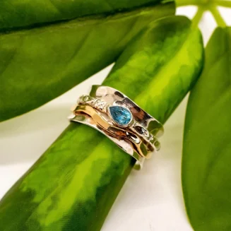 STERLING SILVER WAVE SPINNER/MEDITATION RING WITH BLUE TOPAZ