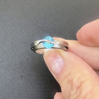 Sterling Silver and Stainless Steel Ring with 7mm blue topaz set with wave tension set size 7.5 only